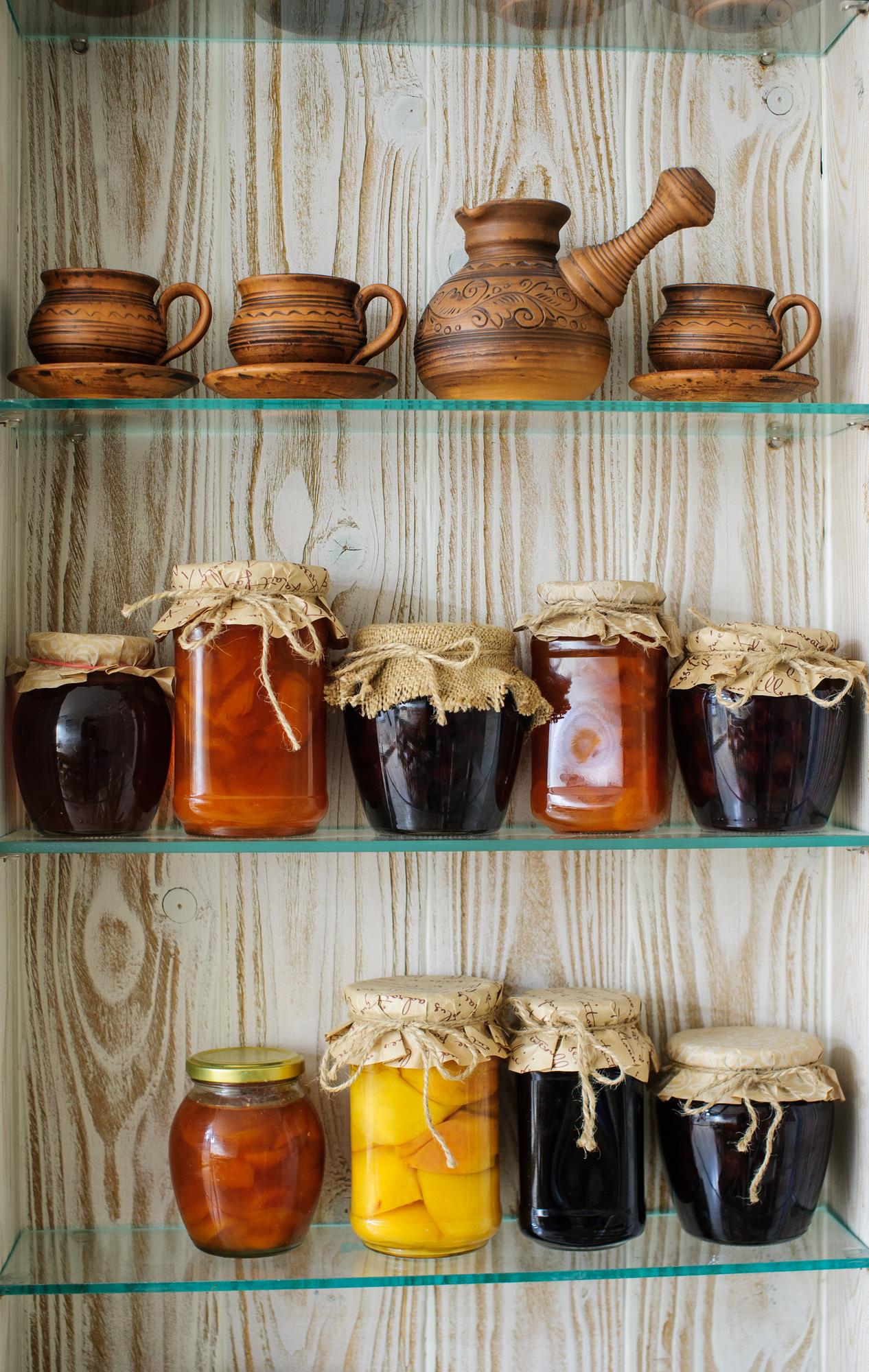 Small-batch preserves in jars on a wooden shelf